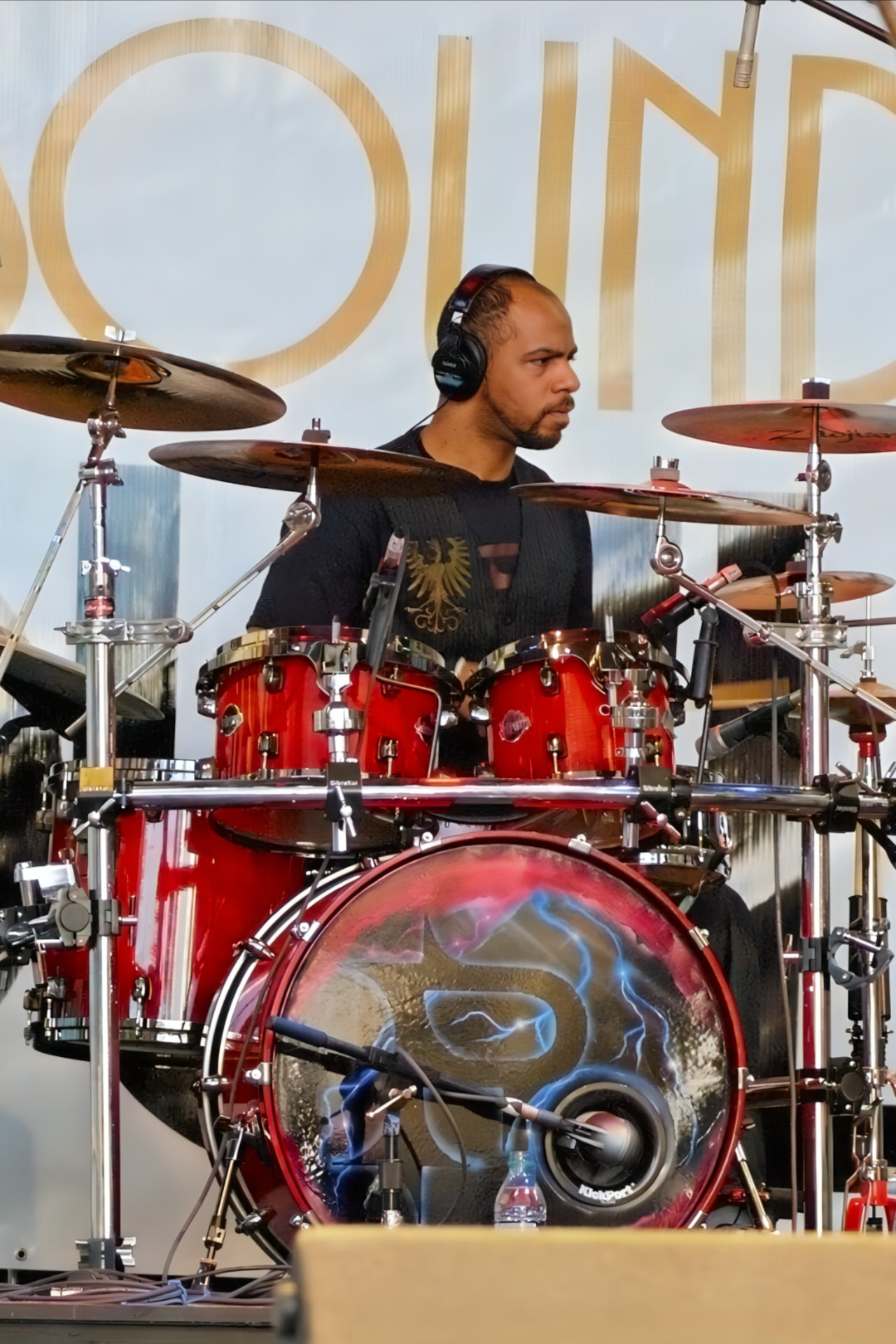 Robert of PAR~A~DIGM behind his red drum kit during a live set