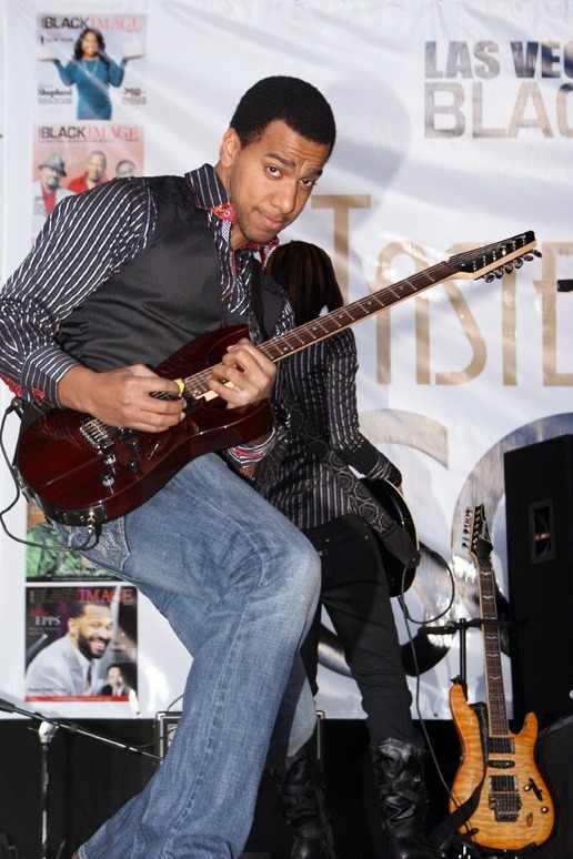 Allen of PAR~A~DIGM playing electric guitar on stage